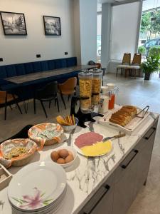 a buffet of food on a table in a room at Central Boutique Hostel in Sarandë