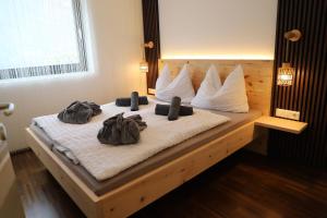a bed with two backpacks on top of it at Maritsch I Apartments in Naturno +52 photos