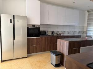 a large kitchen with a stainless steel refrigerator at Villa Max in Krimovice