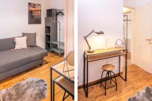 a living room with a couch and a table with a lamp at Stella di Castion in Costermano +25 photos