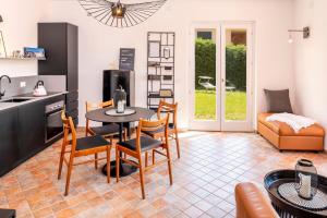 a kitchen and living room with a table and chairs at Stella di Castion in Costermano