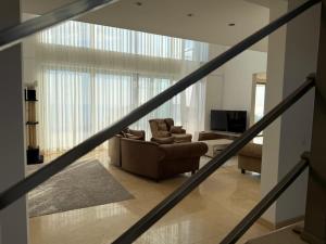 a living room with a couch and a television at Villa Max in Krimovice