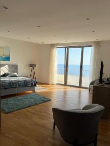 a bedroom with a bed and a view of the ocean at Villa Max in Krimovice +37 photos