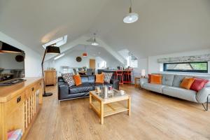 a living room with two couches and a table at The Coach House in Alnwick