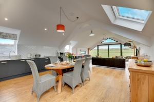 a kitchen and dining room with a table and chairs at The Coach House in Alnwick