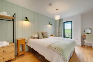 a bedroom with a large bed and a window at The Coach House in Alnwick