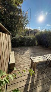 a wooden bench sitting on top of a wooden deck at Ribe Villa in Stockholm