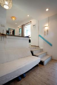 a room with two beds and stairs with a mirror at Dream Villa Beachside Sunset in Ban Bang Po