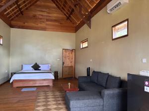 a living room with a bed and a couch at The Sunrise Point in Katiet
