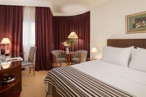 a hotel room with a bed and a table and chairs at Hotel Dubrovnik in Zagreb +33 photos