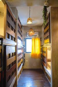 a room with a yellow curtain and a window at Happiness Hostel El Nido in El Nido