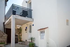 a white house with a staircase on the side of it at Fonte Perila House in Funtana
