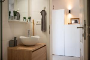 a bathroom with a white bowl sink on a wooden cabinet at Fonte Perila House in Funtana +29 photos