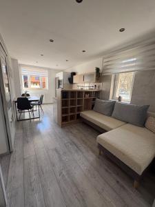 a living room with a couch and a table at Apartmán Olive in Terchová