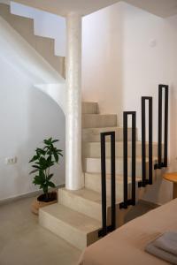 a staircase with a column and a potted plant at Fonte Perila House in Funtana