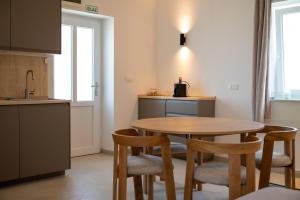 a kitchen with a table and chairs in a room at Fonte Perila House in Funtana