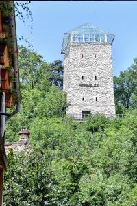 a tall stone tower sitting on top of a hill at Casa Baritiu Rooms in Braşov