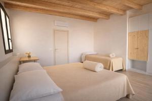a white room with two beds and a window at Agriturismo Verdecielo in Padova +44 photos