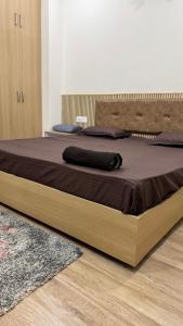 a large bed with a wooden frame in a bedroom at Healer home in Rishīkesh +7 photos