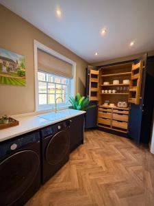 a kitchen with a sink and a dishwasher at La Mancha Hall Stately Home in Halsall