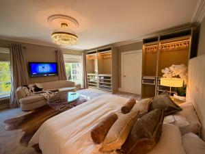 a large bedroom with a large bed and a tv at La Mancha Hall Stately Home in Halsall +72 photos