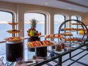 a buffet on a cruise ship with many plates of food at Queen Elizabeth 2 Hotel in Dubai