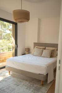 a bedroom with a large bed with a large window at Strada Rossa in Lecci +91 photos