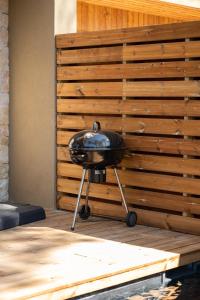 a black grill sitting on a wooden deck at Strada Rossa in Lecci