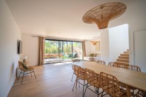 a dining room with a large wooden table and chairs at Strada Rossa in Lecci