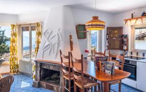 a kitchen and dining room with a table and a fireplace at Lugano Hills View & Parking in Bigorio