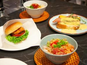 a table with plates of food and a sandwich and salad at Tokyu Stay Hakata in Fukuoka