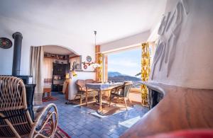 a dining room with a table and a window at Lugano Hills View & Parking in Bigorio +51 photos