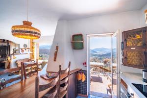 a kitchen and dining room with a view of the mountains at Lugano Hills View & Parking in Bigorio