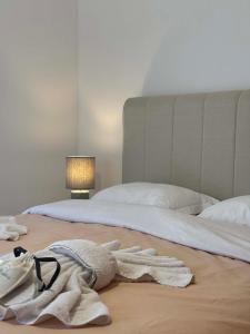 a bedroom with two beds with towels on the floor at La Pietra Maisonettes in Neokhórion