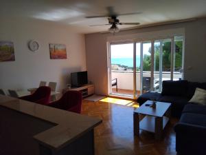 a living room with a view of the ocean at Apartman Baška Voda in Baška Voda