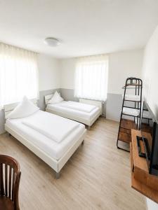 a bedroom with two beds and a ladder in it at FlyInn-Pension Airport-Messe in Leinfelden-Echterdingen