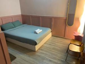 a bedroom with a bed with two towels on it at 75 Staytion in Bien Hoa