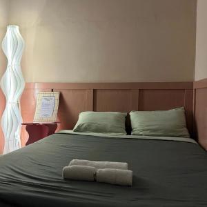 a bed with two towels sitting on top of it at 75 Staytion in Bien Hoa +10 photos