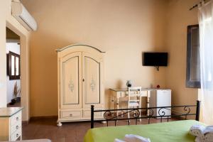 a bedroom with a white cabinet and a refrigerator at La Locanda degli Amici in Santa Teresa di Riva