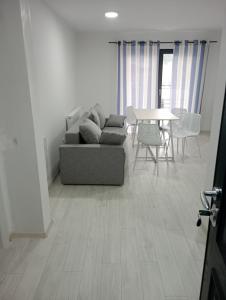 a living room with a couch and a table at Deluxe apartament Vatra Dornei in Vatra Dornei