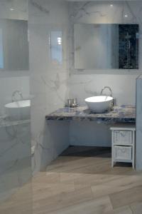 a bathroom with two sinks and a mirror at Casa Martini in Bonifacio +57 photos