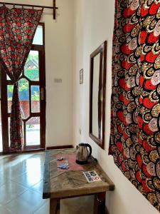 a room with a table and a wall with plates at vayana nungwi in Nungwi