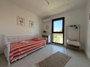a bedroom with a bed and a window and a mirror at Villa ROC in Bandol