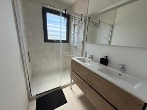 a bathroom with a shower and a sink and a mirror at Villa ROC in Bandol +4 photos