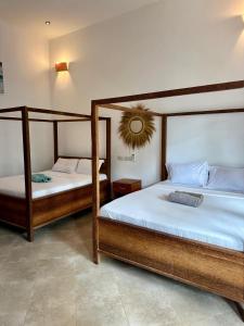 two beds in a room with twothirdsessionsyss at vayana nungwi in Nungwi