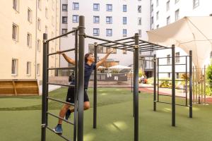 a man on a monkey bars on a playground at Hotel Zeitgeist Vienna Hauptbahnhof in Vienna