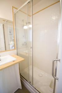 a bathroom with a glass shower and a sink at La Casa del Petirrojo de Ribamontan al Mar con Surf y Tranquilidad in Castanedo