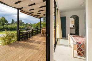 a deck with a view of the yard at m&m in Vourvourou