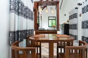 a dining room with a table and chairs at JY Apartments in Negombo