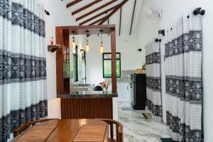 a dining room with a table and a sink at JY Apartments in Negombo +34 photos